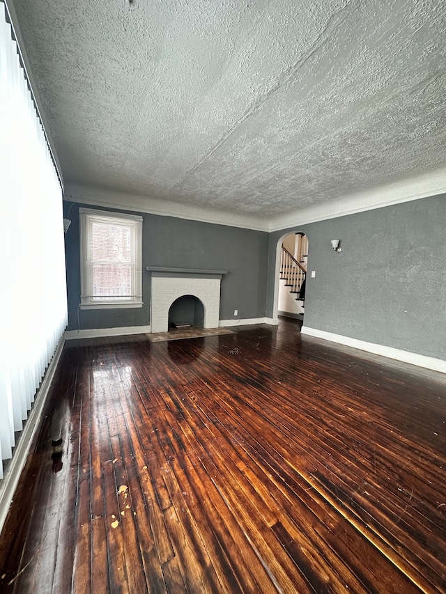 unfurnished living room with hardwood / wood-style floors and a fireplace