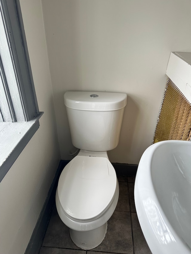 bathroom with tile patterned flooring, sink, and toilet