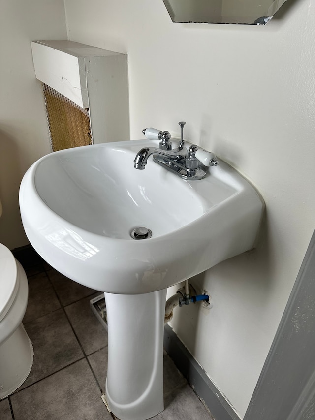 bathroom with tile patterned floors, toilet, and sink