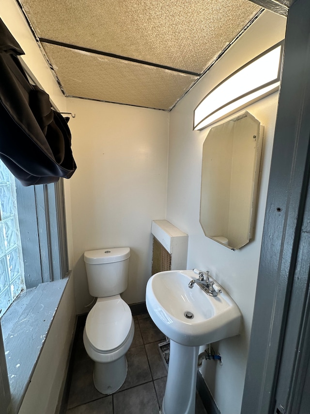 bathroom featuring tile patterned floors and toilet