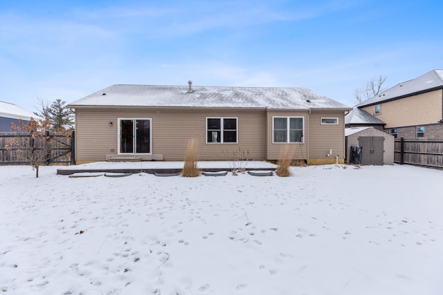 snow covered property with a shed