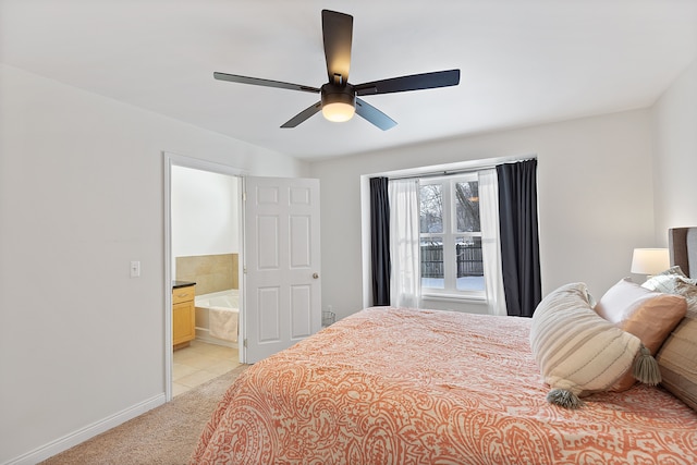 bedroom featuring ceiling fan, ensuite bathroom, and light carpet