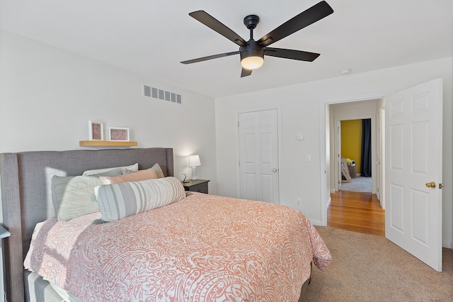 bedroom with light colored carpet and ceiling fan