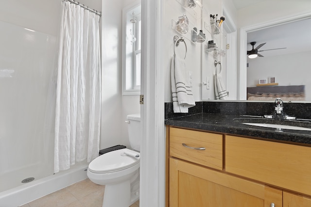 bathroom with curtained shower, tile patterned floors, vanity, toilet, and ceiling fan