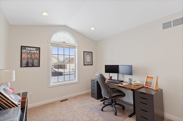 office area featuring light colored carpet and lofted ceiling