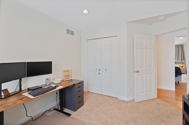 carpeted office with vaulted ceiling