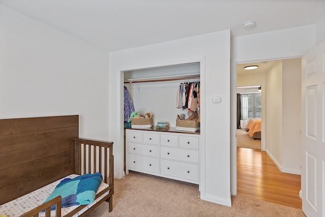 carpeted bedroom with a closet