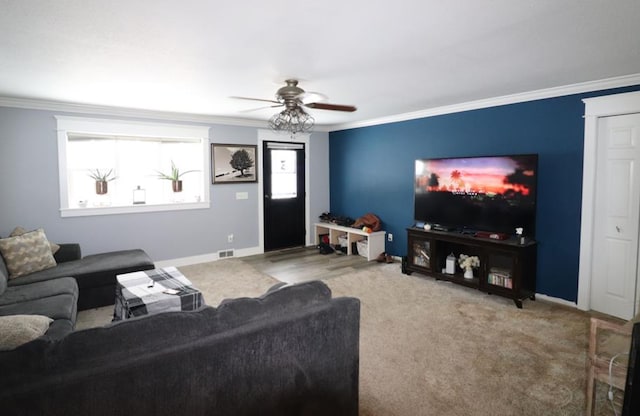 living room featuring carpet, ceiling fan, and ornamental molding