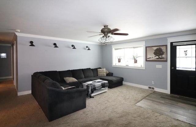 carpeted living room featuring crown molding and ceiling fan