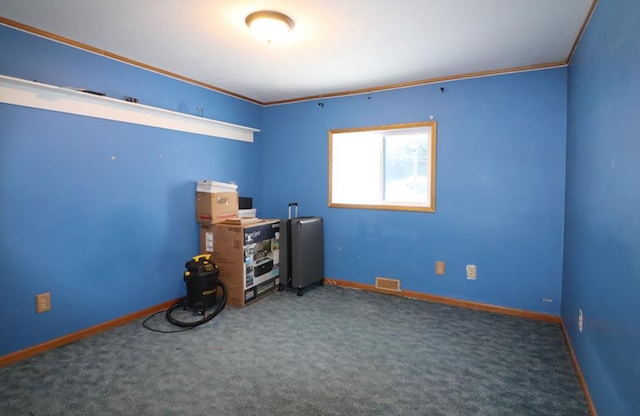 misc room featuring dark carpet and crown molding