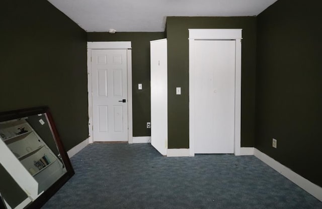 unfurnished bedroom featuring dark colored carpet