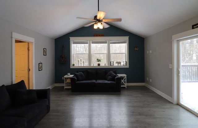 living room featuring vaulted ceiling, a wealth of natural light, and dark hardwood / wood-style flooring