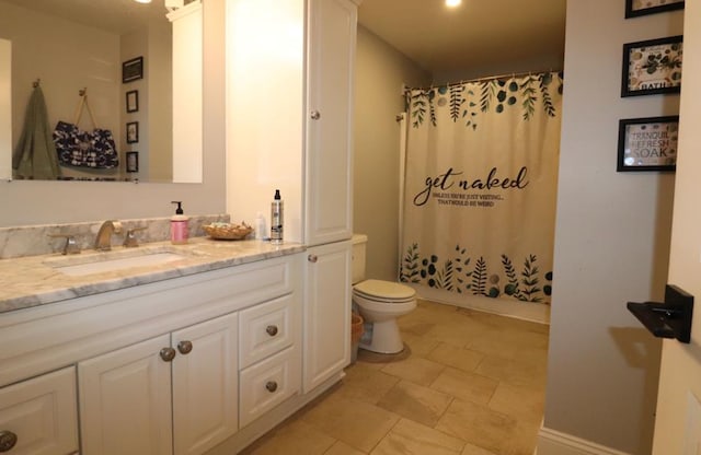 bathroom featuring vanity, toilet, and a shower with shower curtain