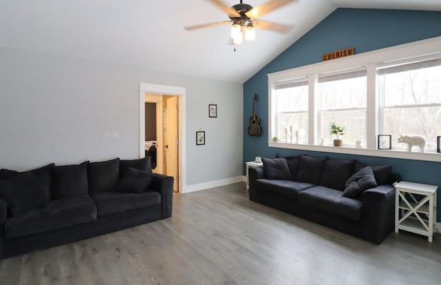 living room featuring ceiling fan, hardwood / wood-style floors, and lofted ceiling