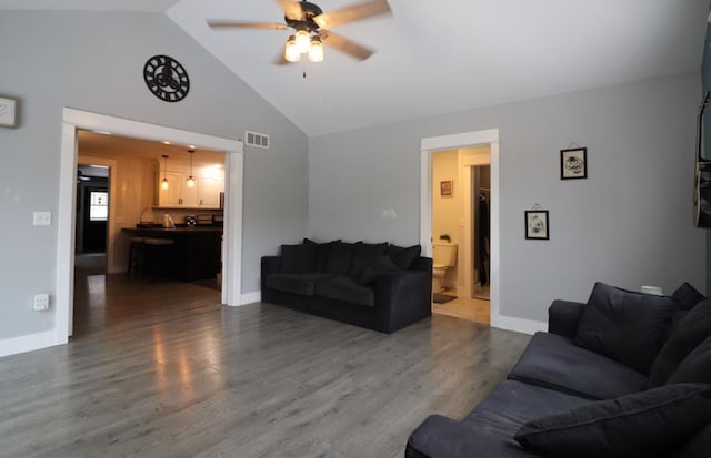 living room with hardwood / wood-style floors, vaulted ceiling, and ceiling fan