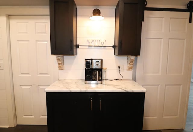 kitchen featuring light stone counters and tasteful backsplash