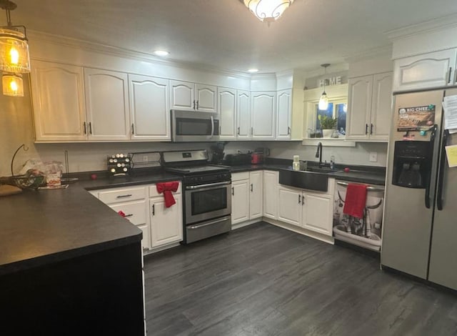 kitchen with decorative light fixtures, sink, white cabinetry, dark hardwood / wood-style floors, and stainless steel appliances