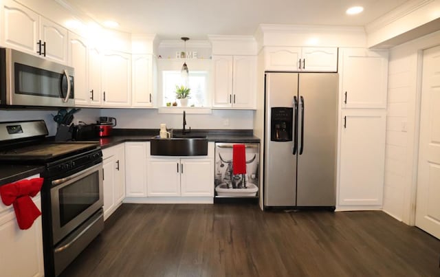 kitchen featuring dark wood-type flooring, sink, white cabinets, and stainless steel appliances