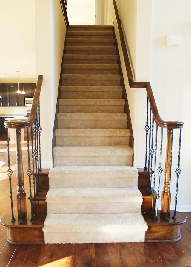 staircase featuring wood-type flooring