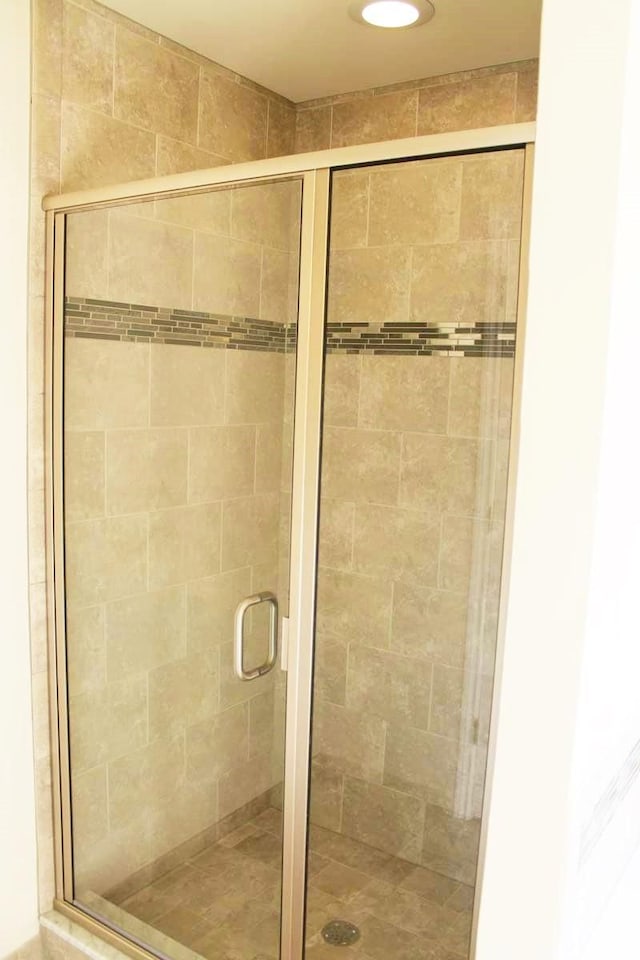 bathroom with a shower with door