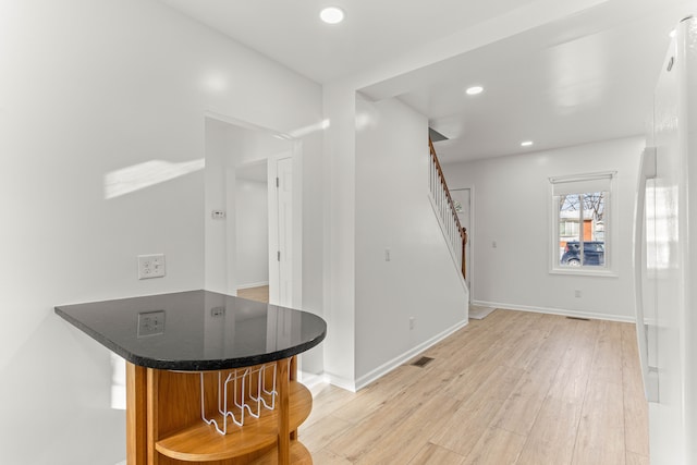 bar featuring light hardwood / wood-style flooring