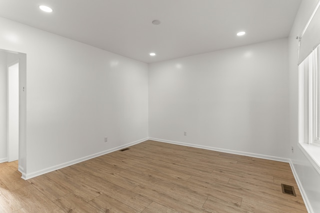 spare room featuring light hardwood / wood-style flooring