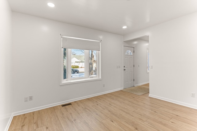 spare room featuring light wood-type flooring