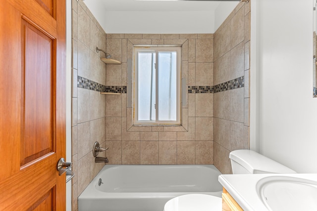 full bathroom featuring toilet, vanity, and tiled shower / bath combo