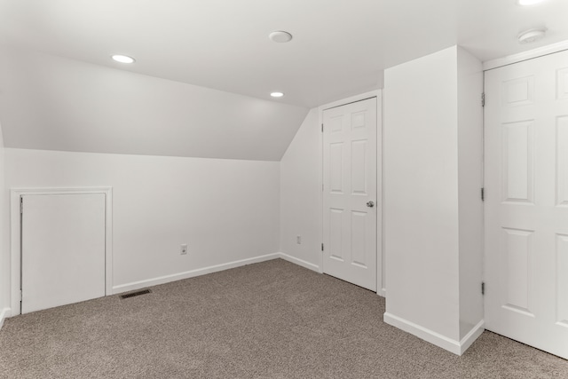 additional living space with lofted ceiling and carpet flooring