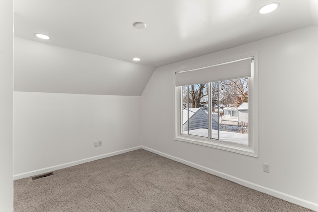 bonus room featuring vaulted ceiling and carpet floors