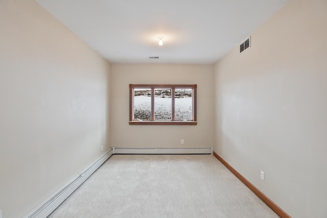 carpeted empty room with a baseboard heating unit