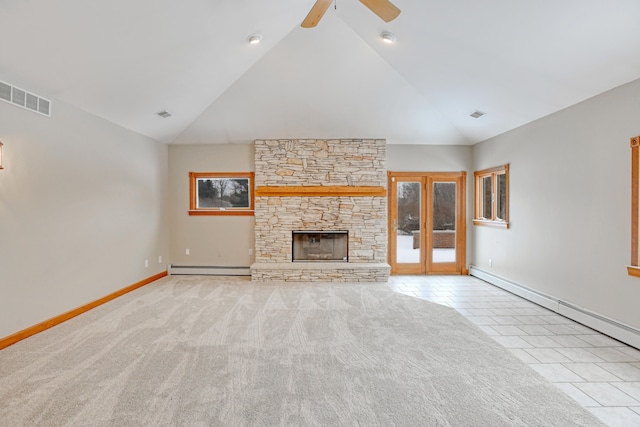 unfurnished living room with baseboard heating, light tile patterned floors, lofted ceiling, and a fireplace