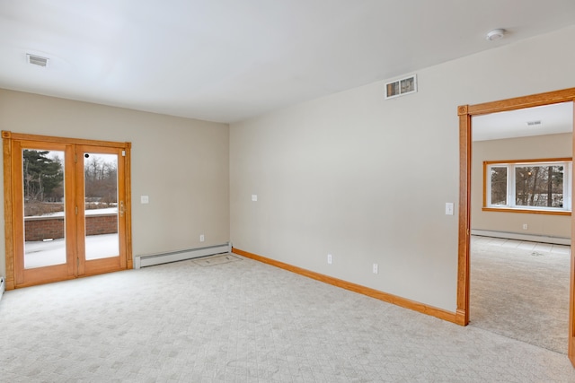 carpeted spare room with a baseboard radiator and plenty of natural light