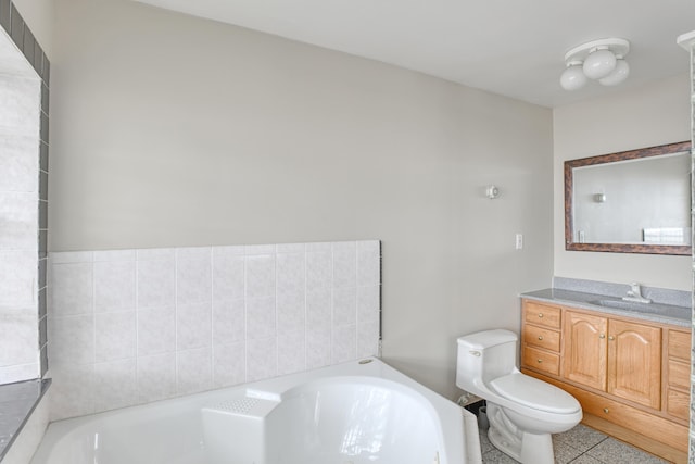 bathroom with toilet, vanity, tile patterned floors, and a bathtub