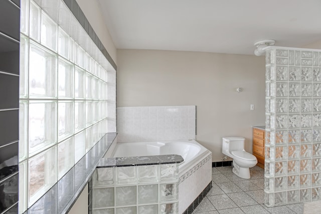 bathroom with toilet and tiled bath