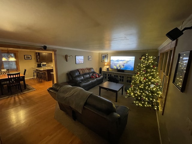 living room with wood-type flooring and ornamental molding