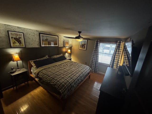 bedroom featuring ceiling fan and dark hardwood / wood-style flooring