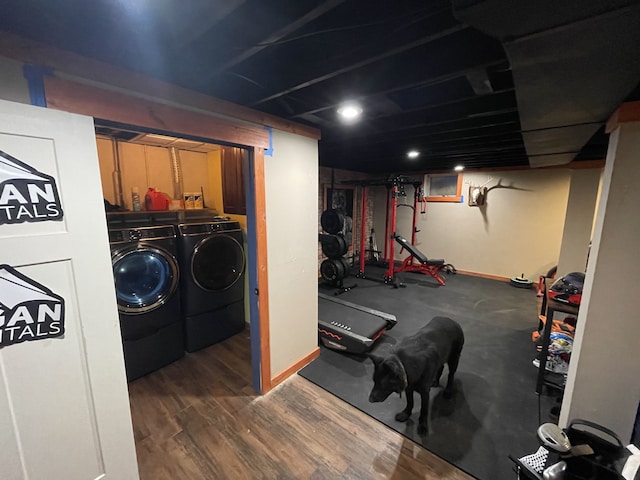 exercise room featuring dark wood-type flooring and washing machine and clothes dryer