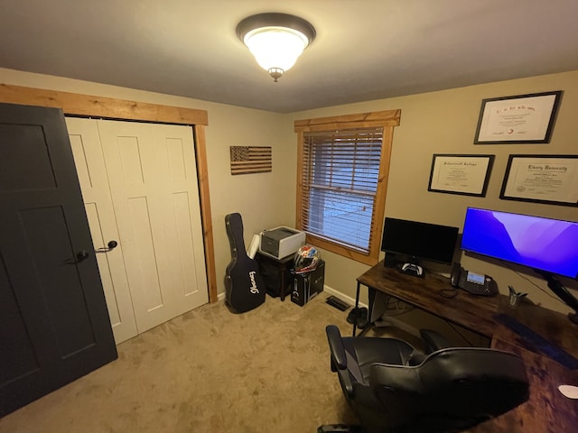 office area with baseboards, visible vents, and light colored carpet