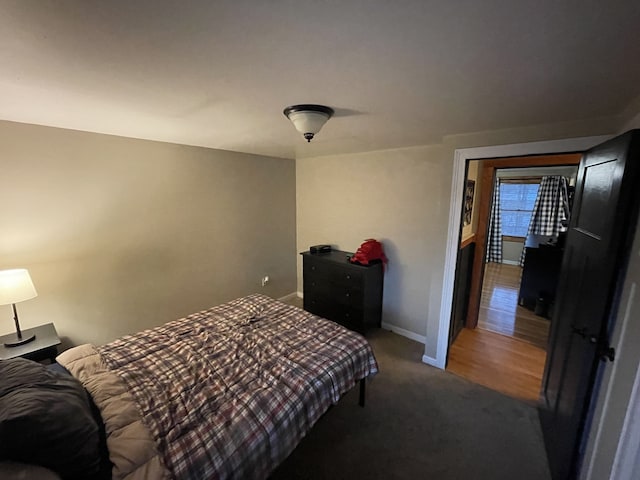 bedroom featuring baseboards and carpet flooring