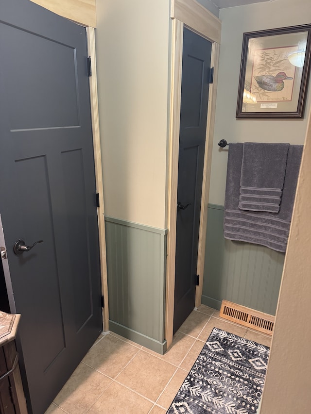 bathroom featuring wainscoting, visible vents, vanity, and tile patterned floors