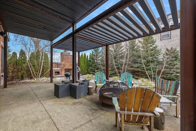 view of patio featuring an outdoor fireplace and an outdoor fire pit