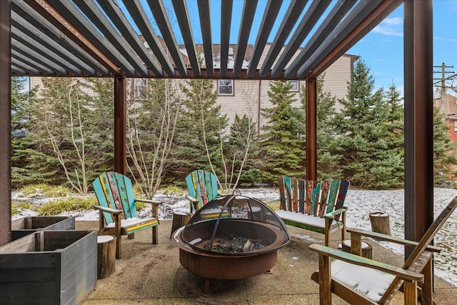 view of patio / terrace with an outdoor fire pit and a pergola