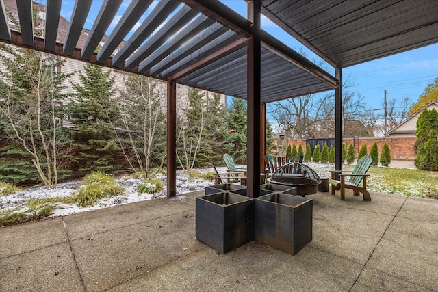 view of patio / terrace with a pergola and a fire pit