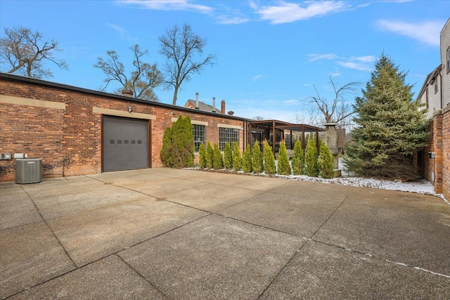 ranch-style house with a garage and central air condition unit