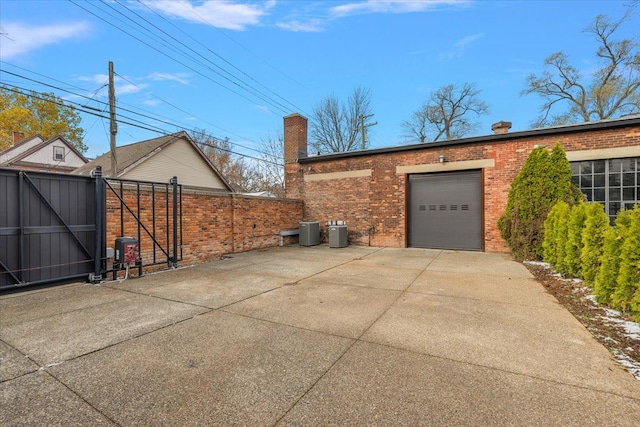 view of home's exterior with cooling unit and a garage