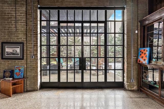 doorway with french doors and brick wall