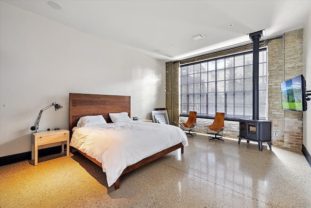 bedroom featuring a wood stove