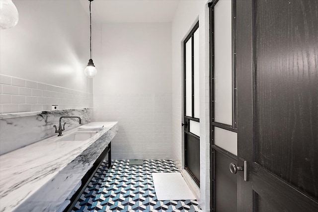 bathroom with tile walls and walk in shower