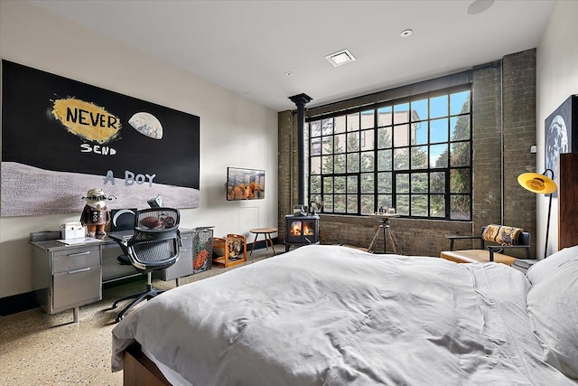 bedroom featuring a wood stove